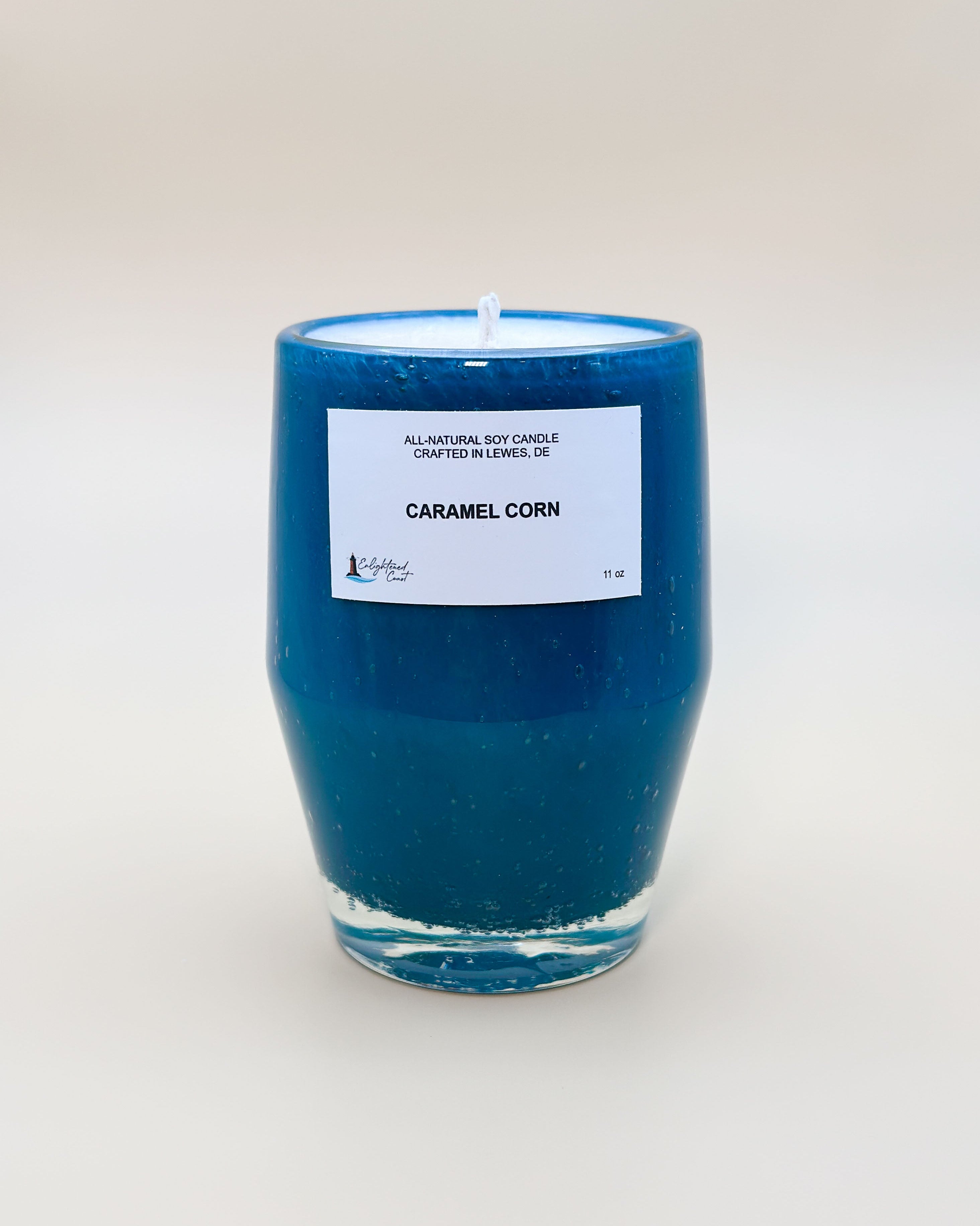 Teal glass candle with Caramel Corn white label