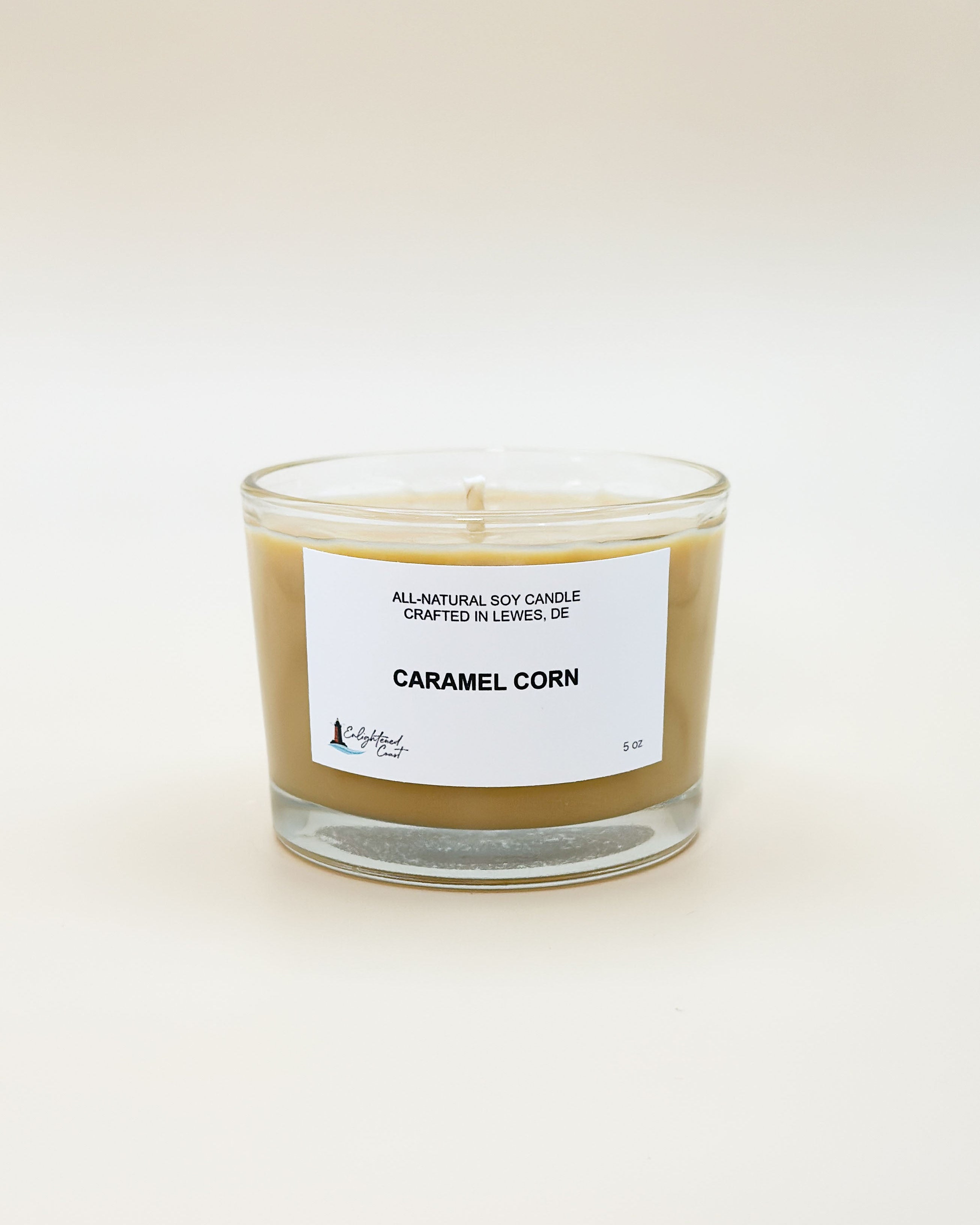 Candle labeled 'Caramel Corn' with a white label on a light beige background