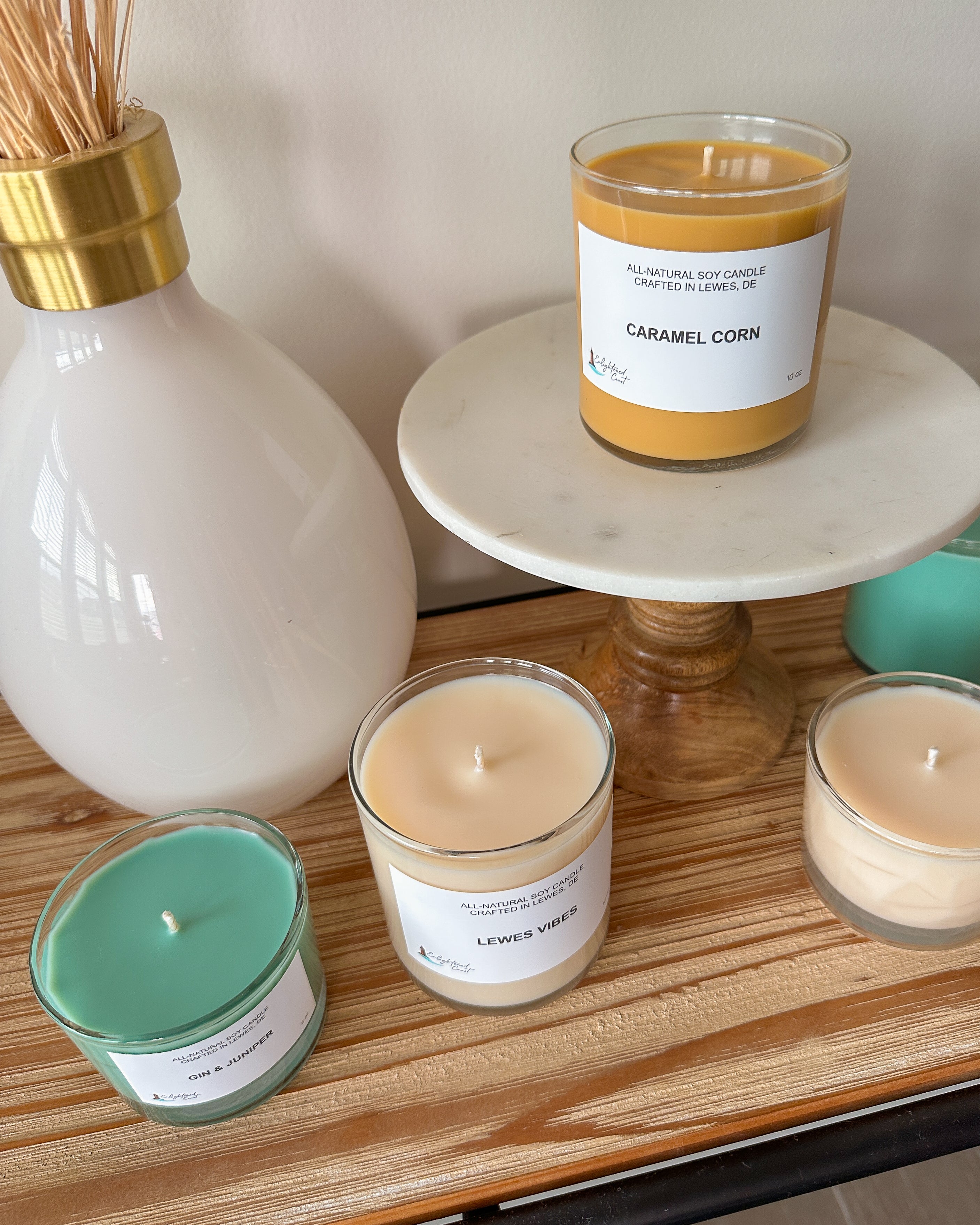 Candle collection with labels on a wooden surface