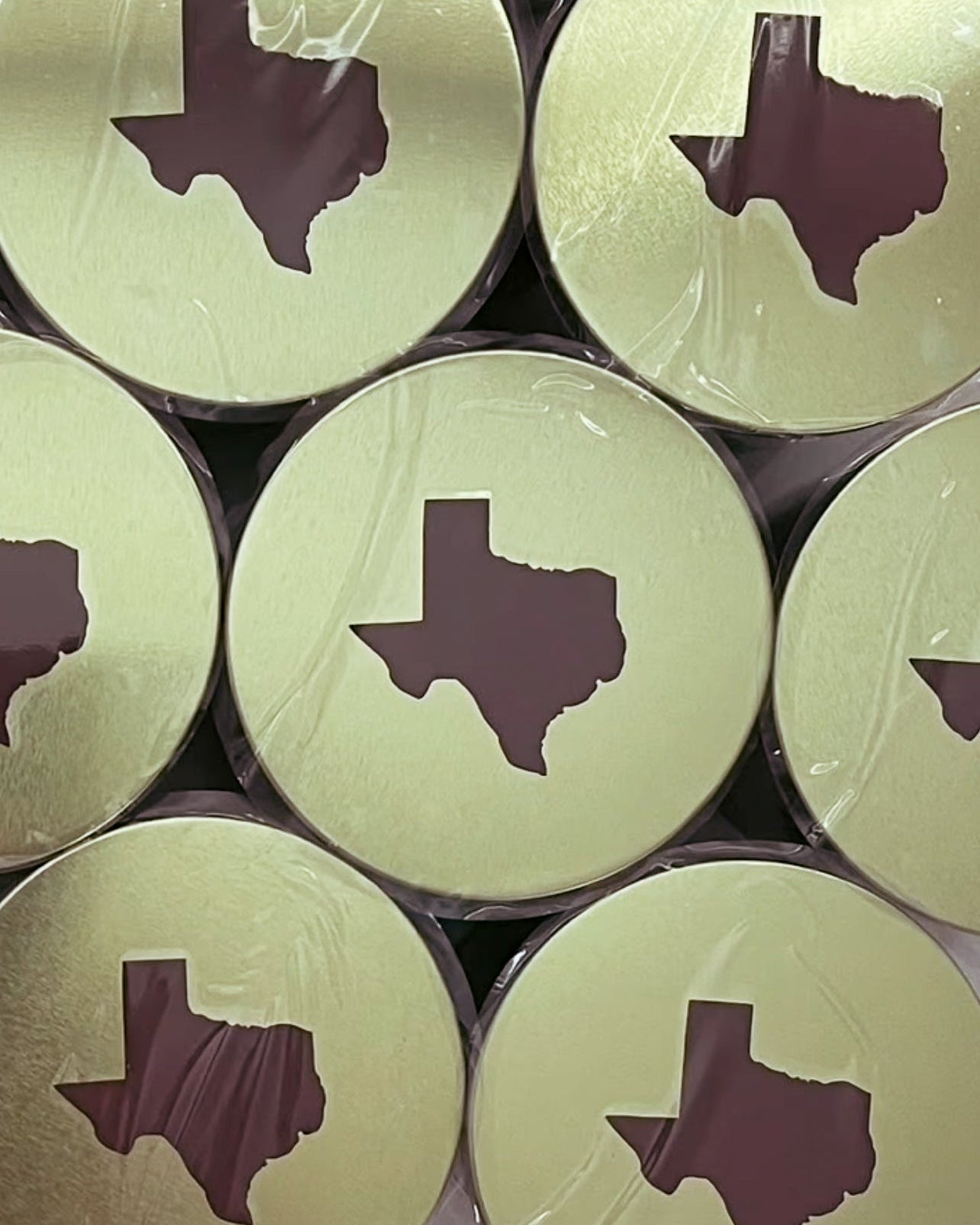 Stack of candle lids with Texas state math strike design