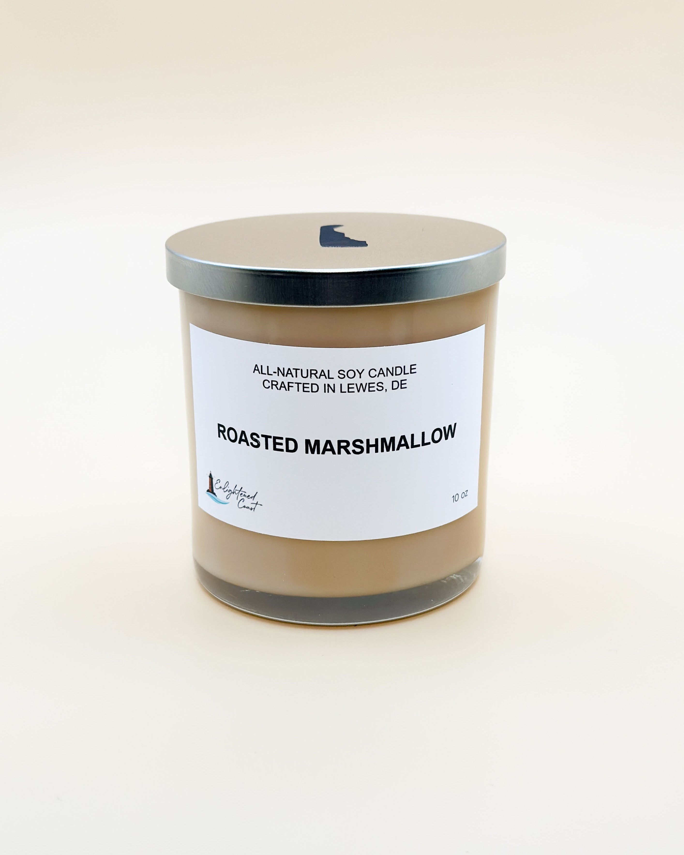 Candle labeled 'Roasted Marshmallow' with a white label on a beige background