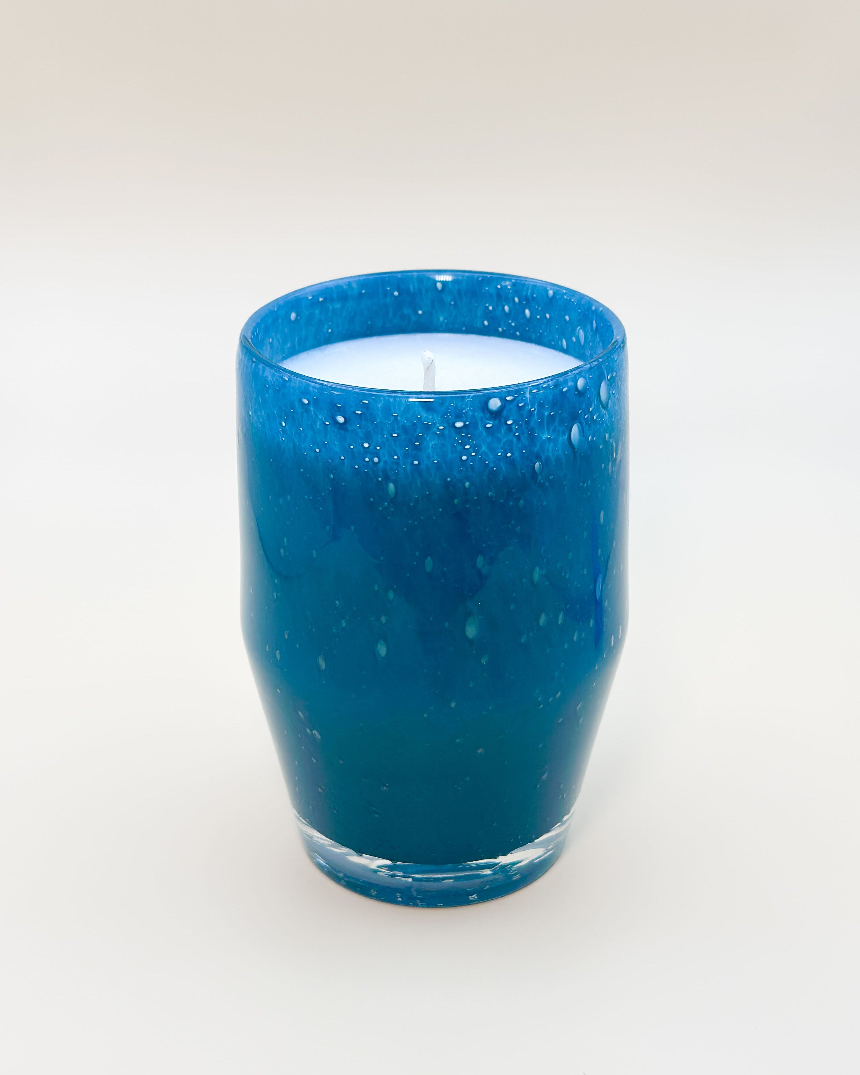 Teal blown glass candle with white wax