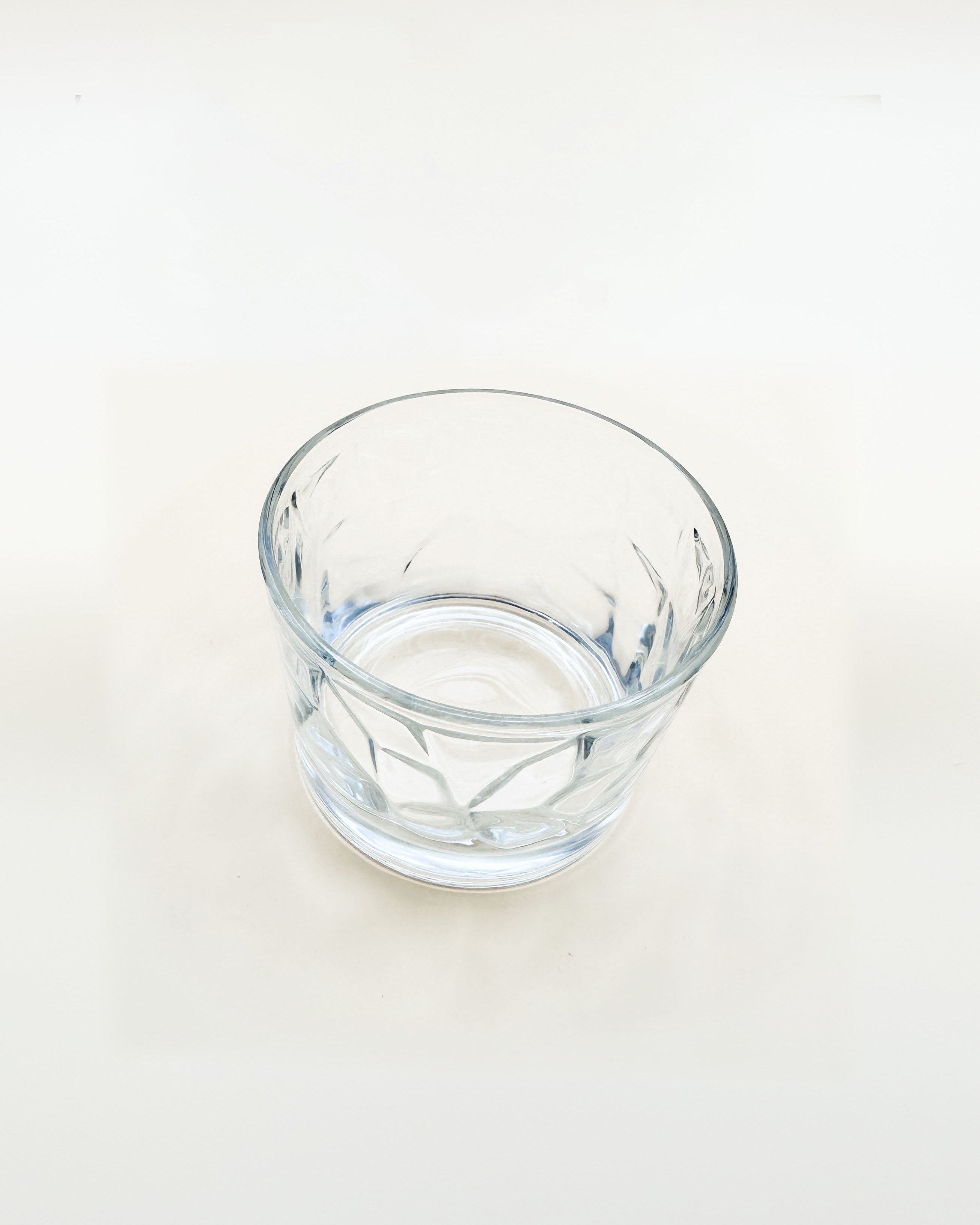Clear glass tumbler on a white background