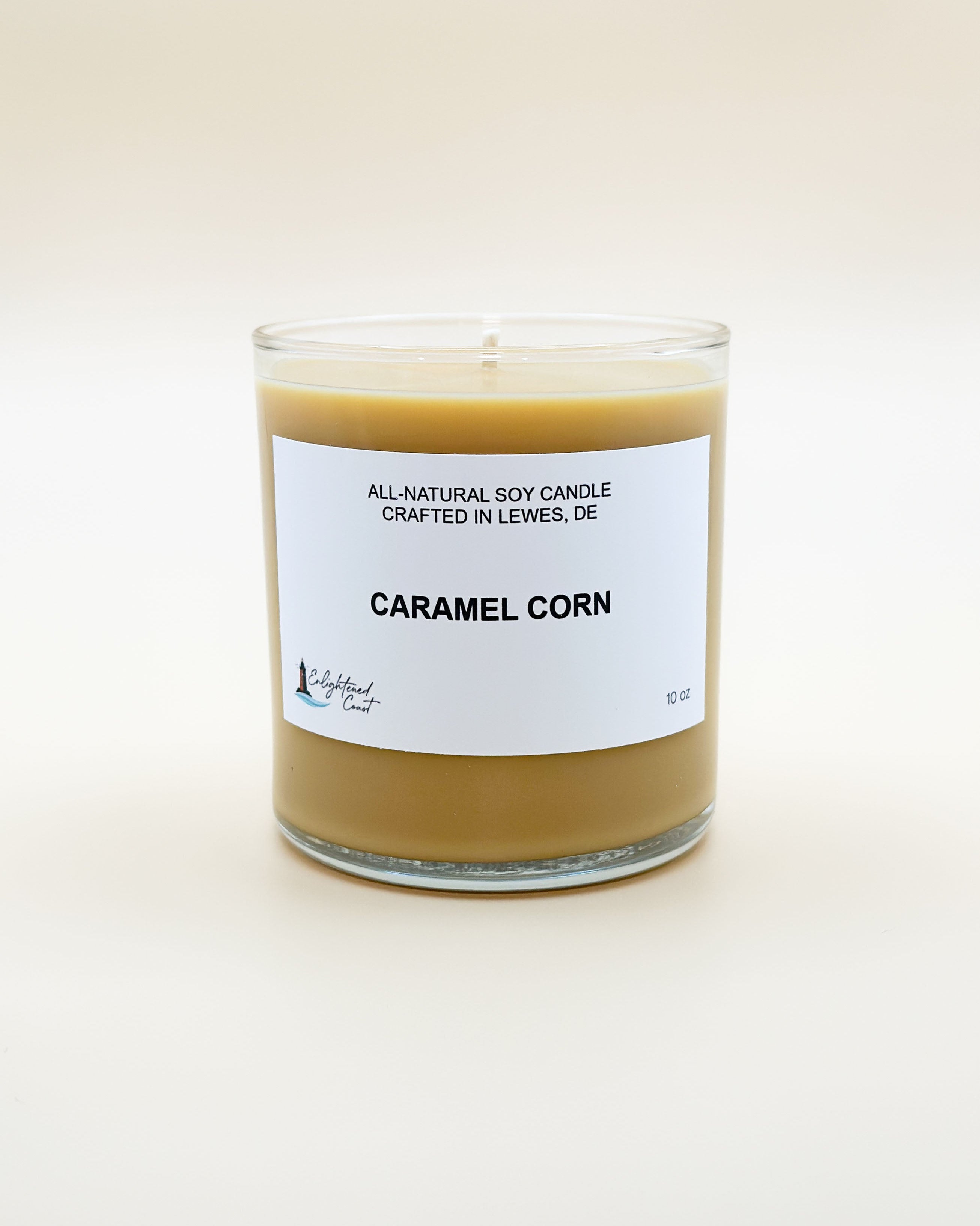 Candle labeled 'Caramel Corn' with a white label on a light background