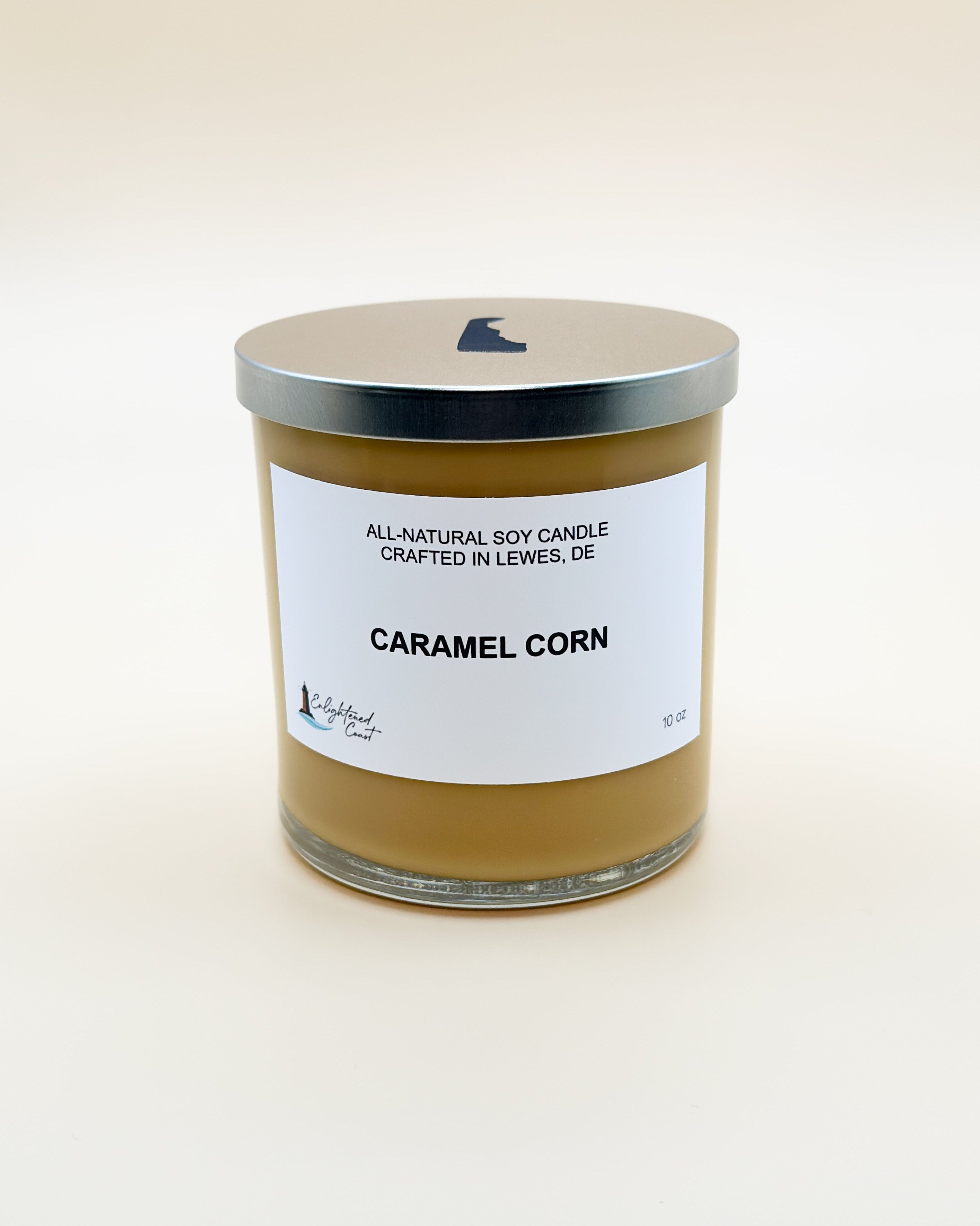 Candle labeled 'Caramel Corn' with a white label on a beige background