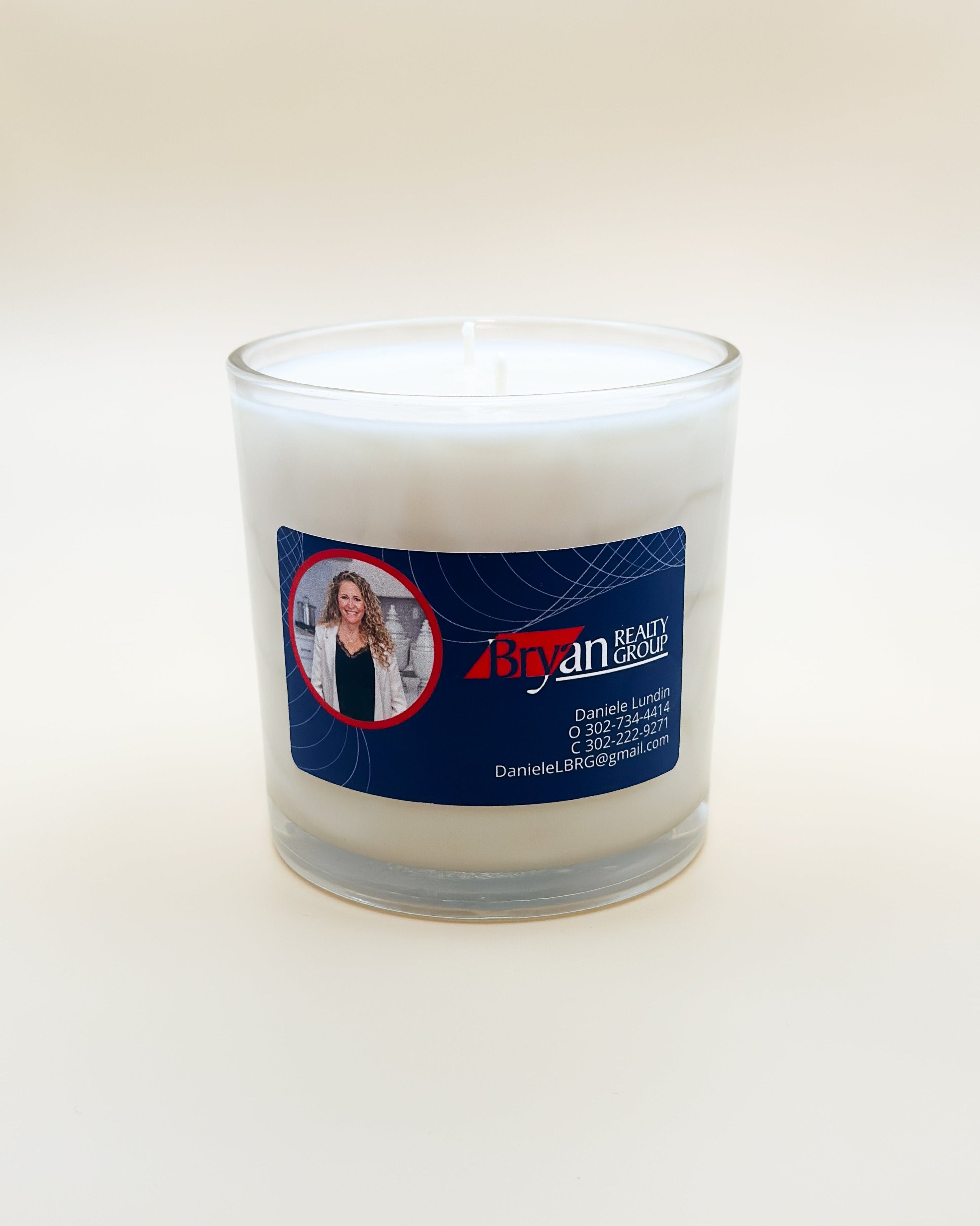 Candle with a label featuring custom realtor label