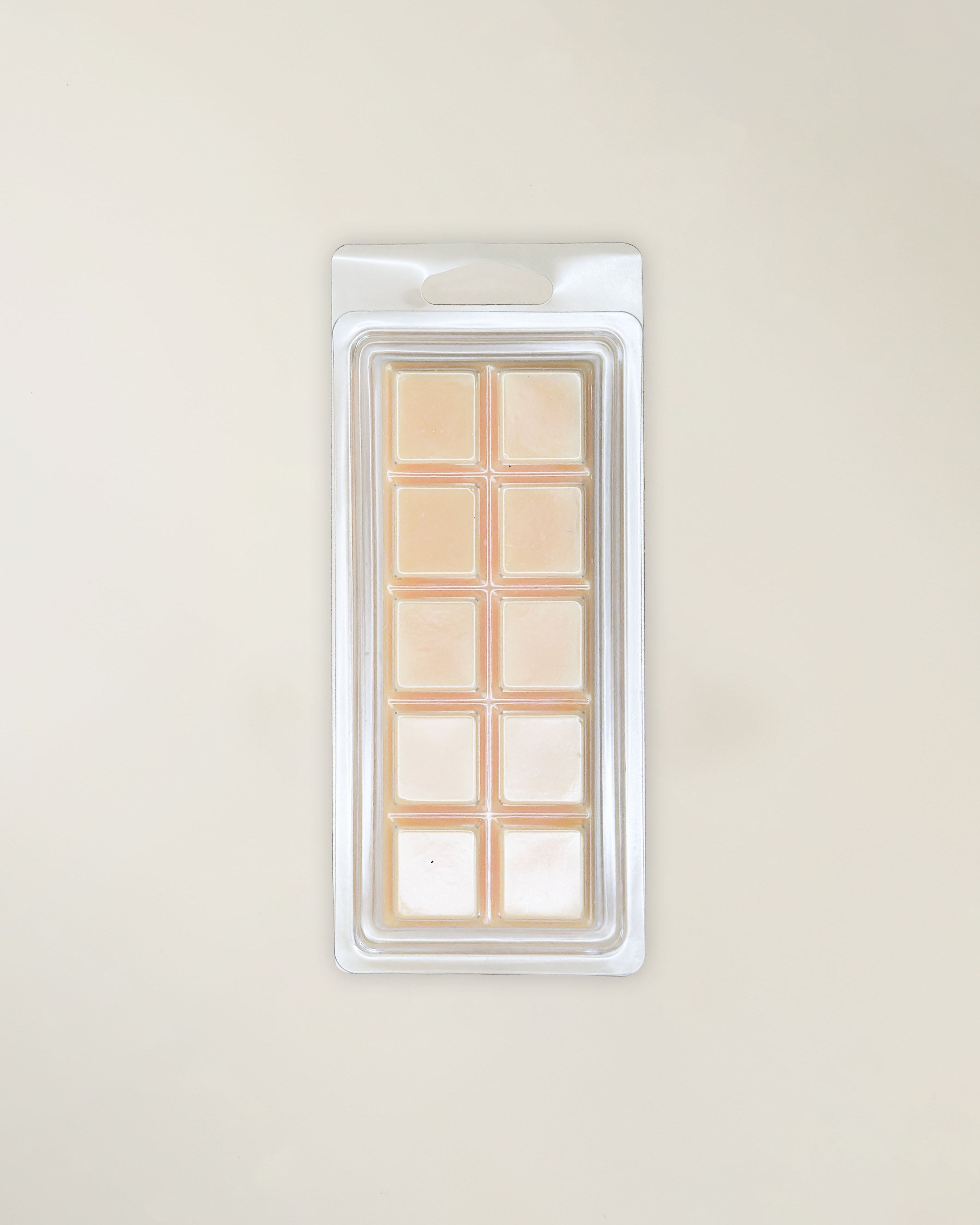 Packaged beige wax melts on a light beige background