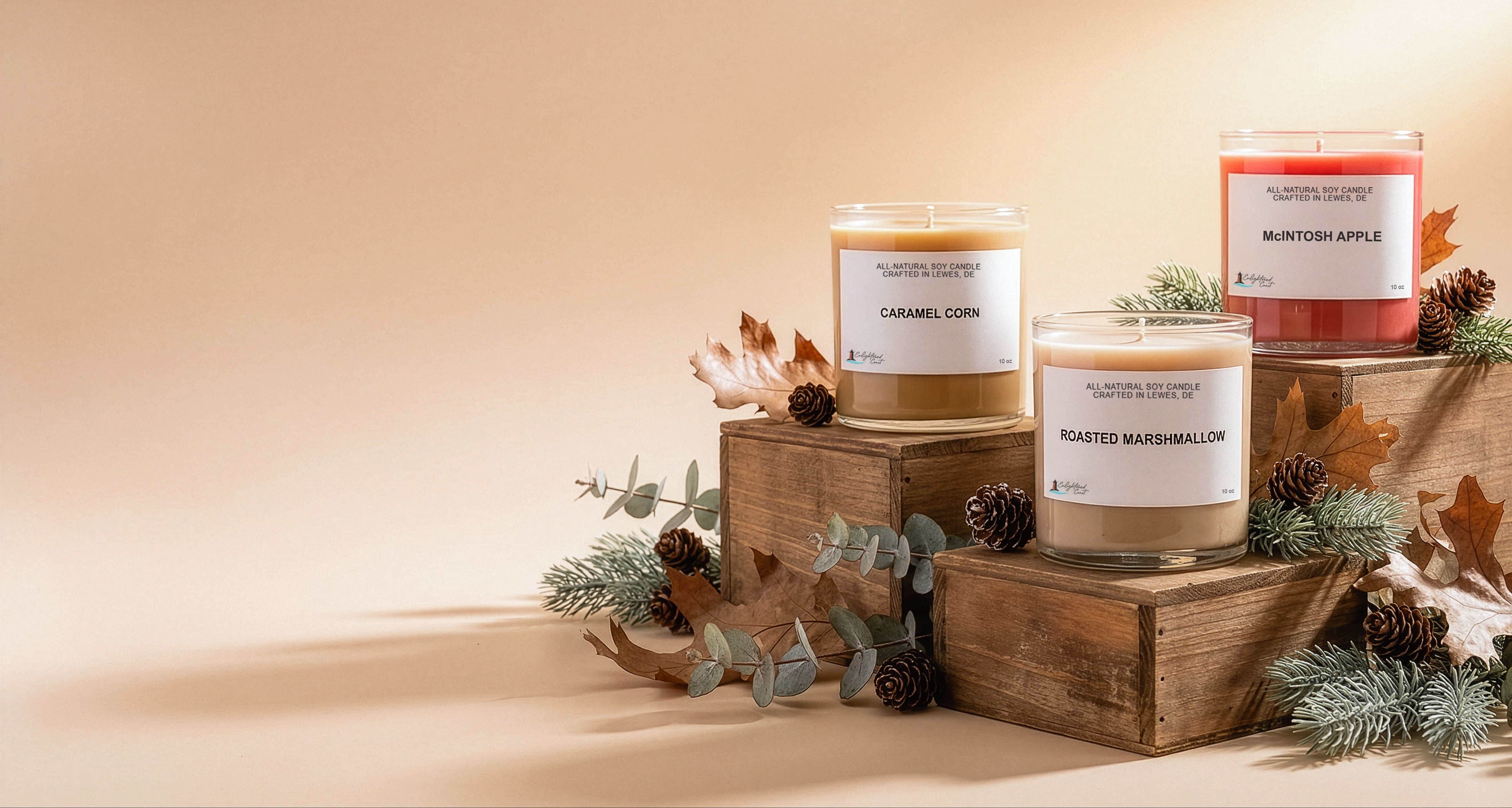 Three candles on wooden stands with decorative elements on a beige background