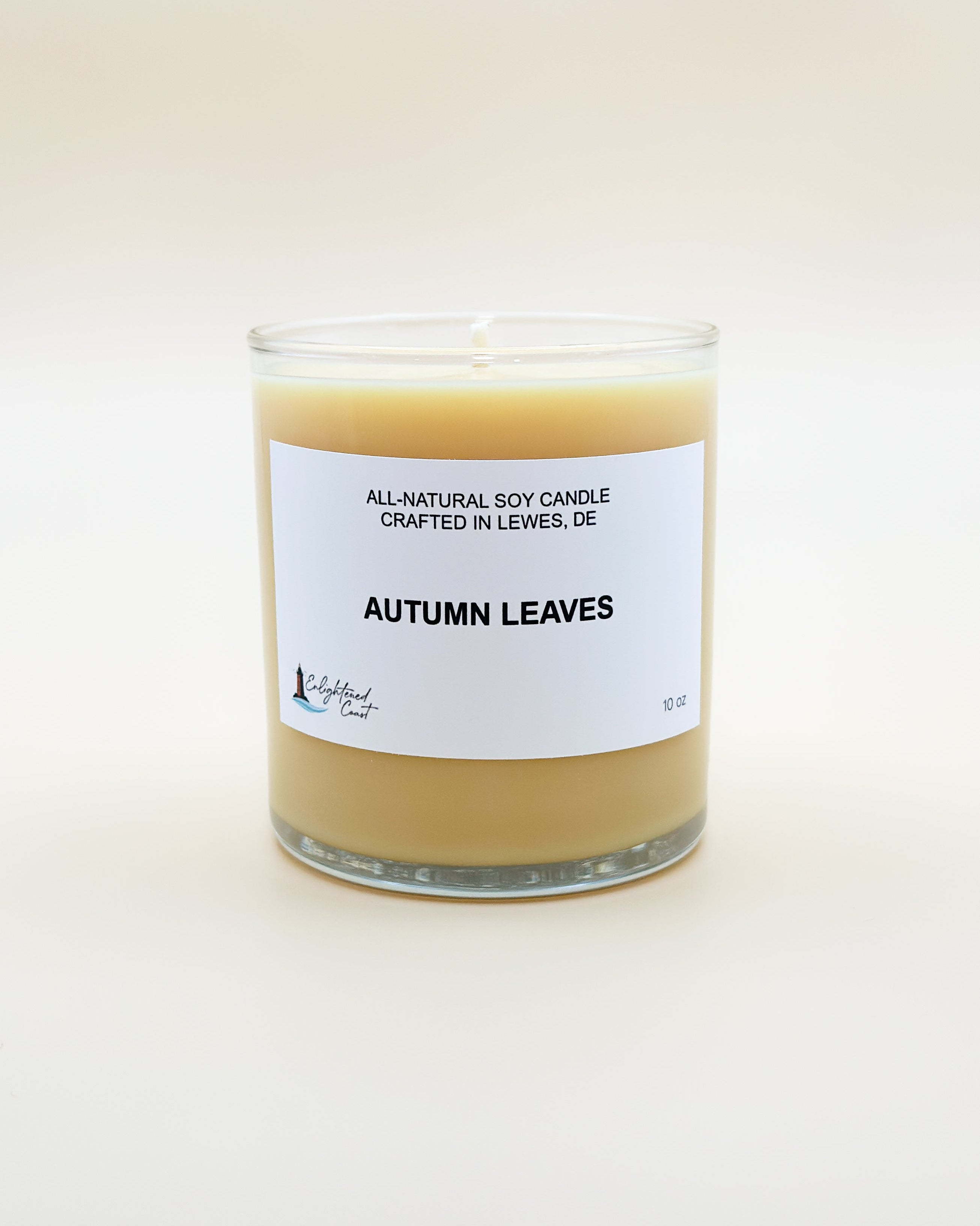 Candle labeled 'Autumn Leaves' with a white label on a light beige background