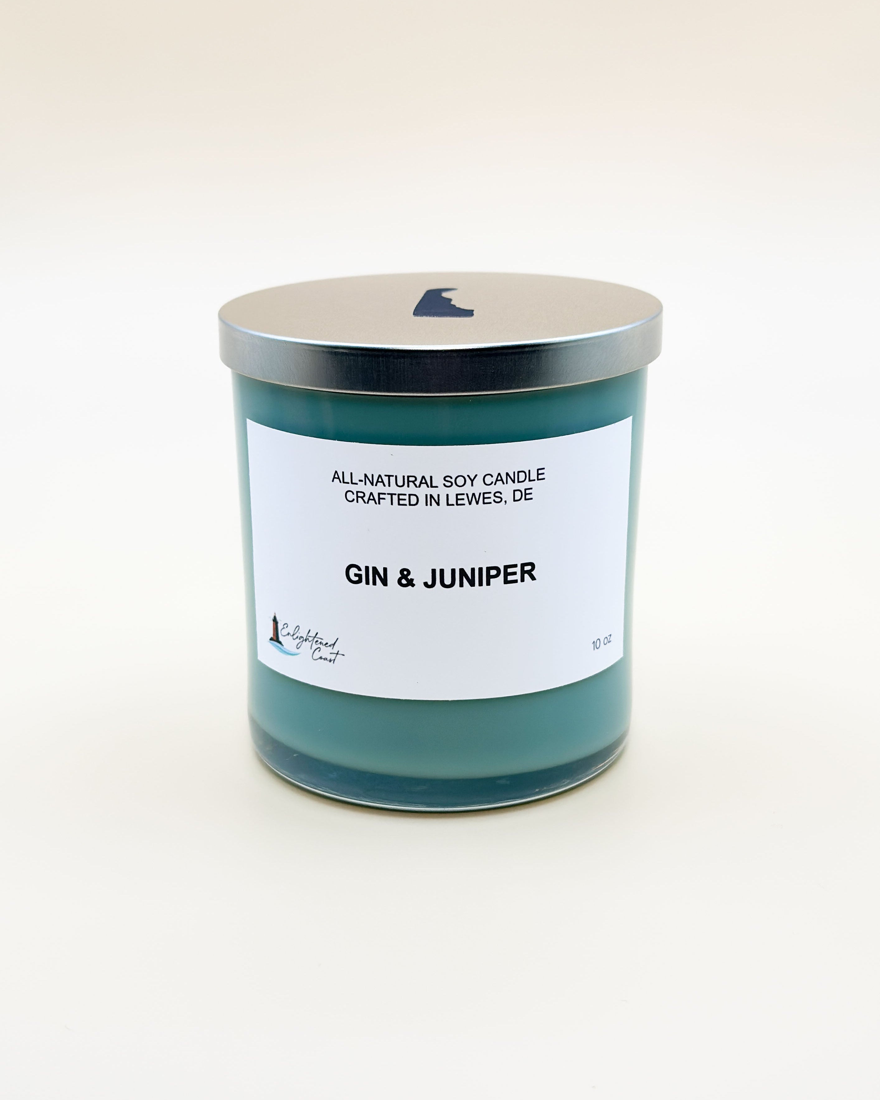 Candle labeled 'Gin & Juniper' with a white label on a light beige background