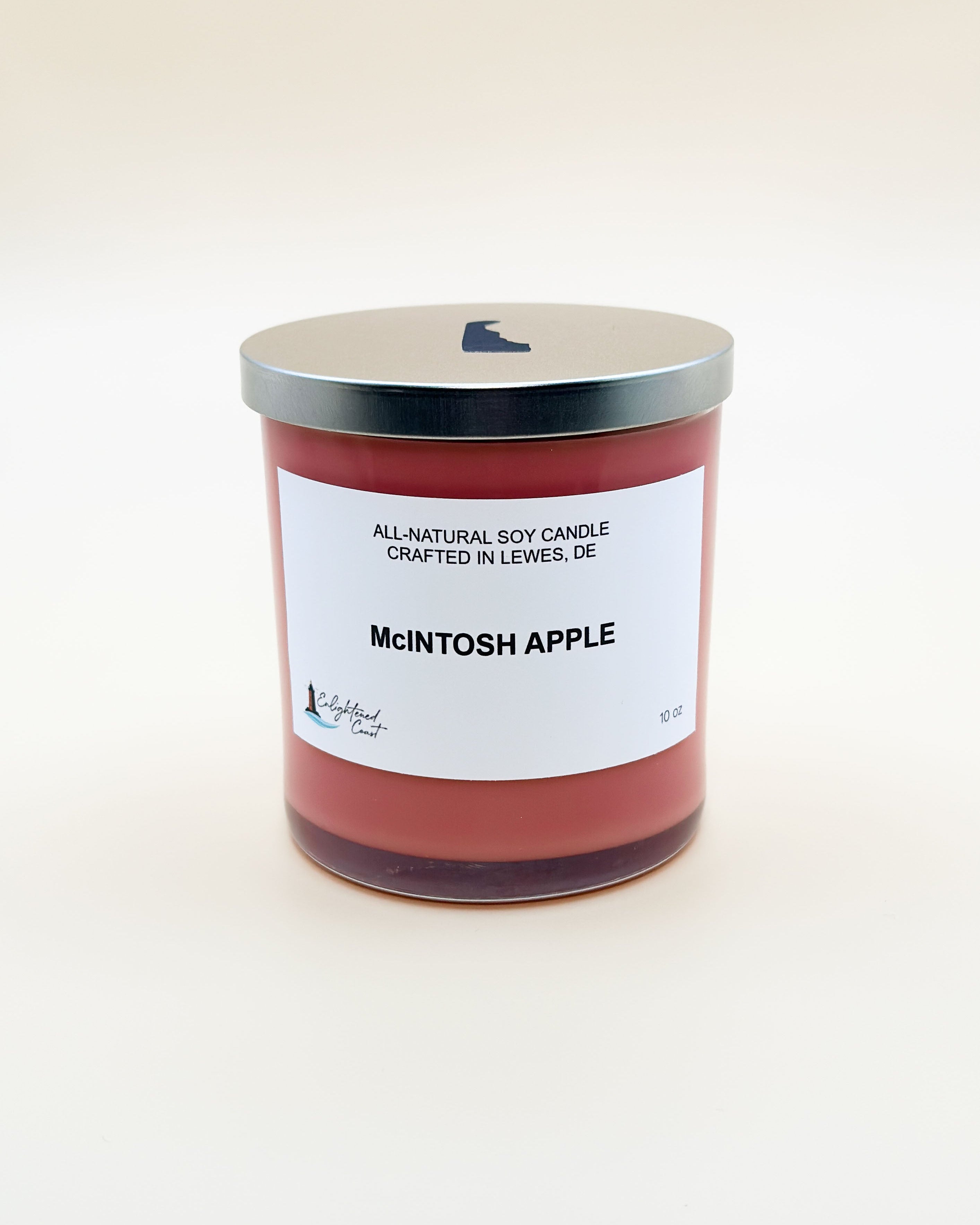 Candle labeled 'McIntosh Apple' with a white label on a light beige background