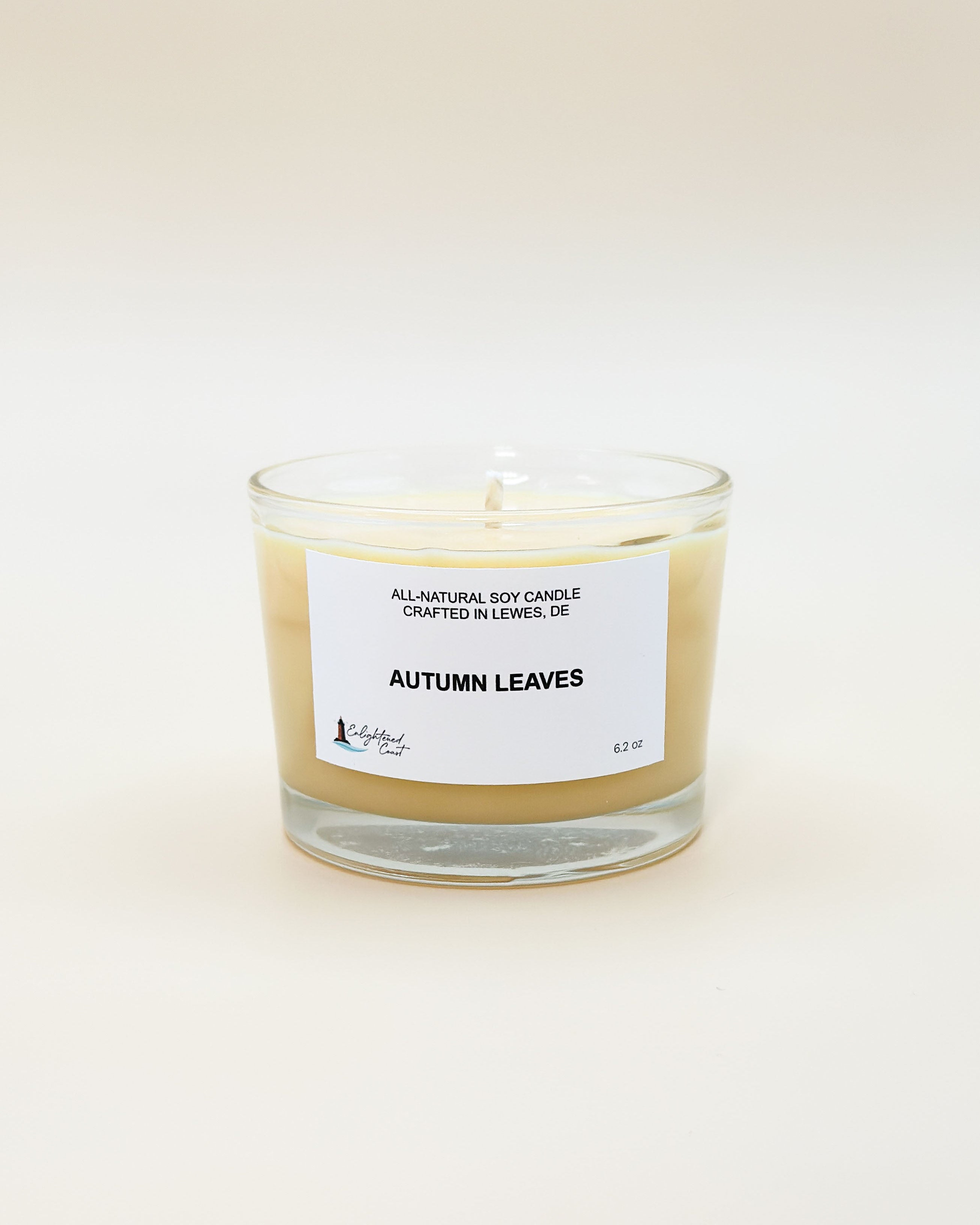 Candle labeled 'Autumn Leaves' on a white background