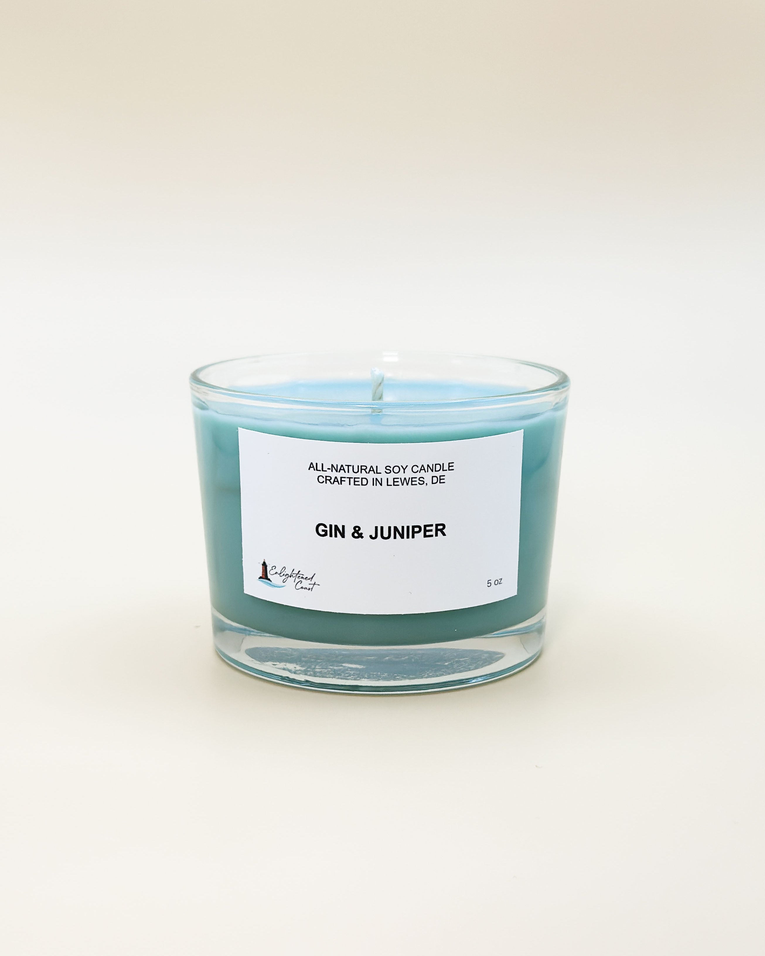Candle labeled 'Gin & Juniper' on a white background