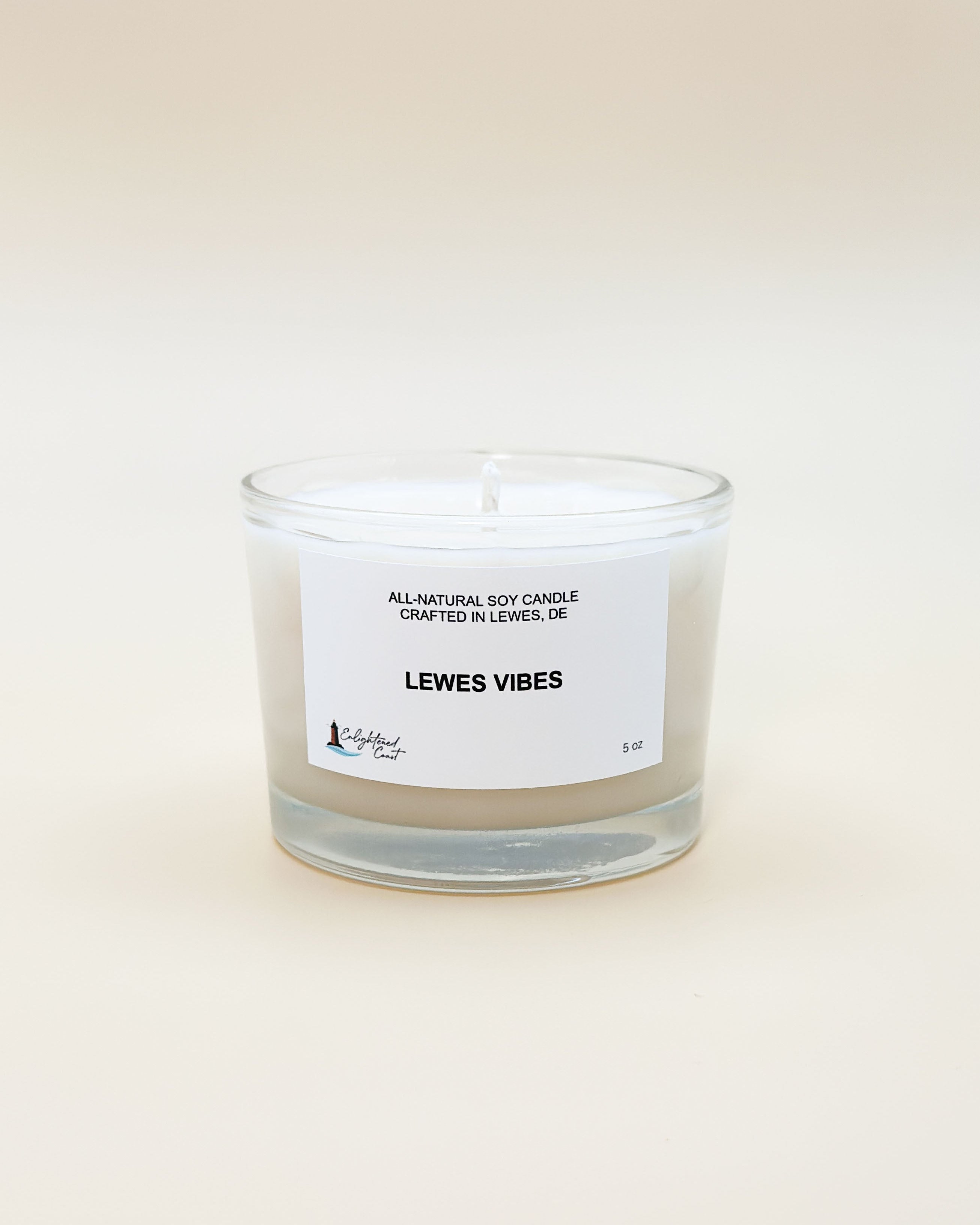 Clear candle with a white label 'Lewes Vibes' on a light beige background