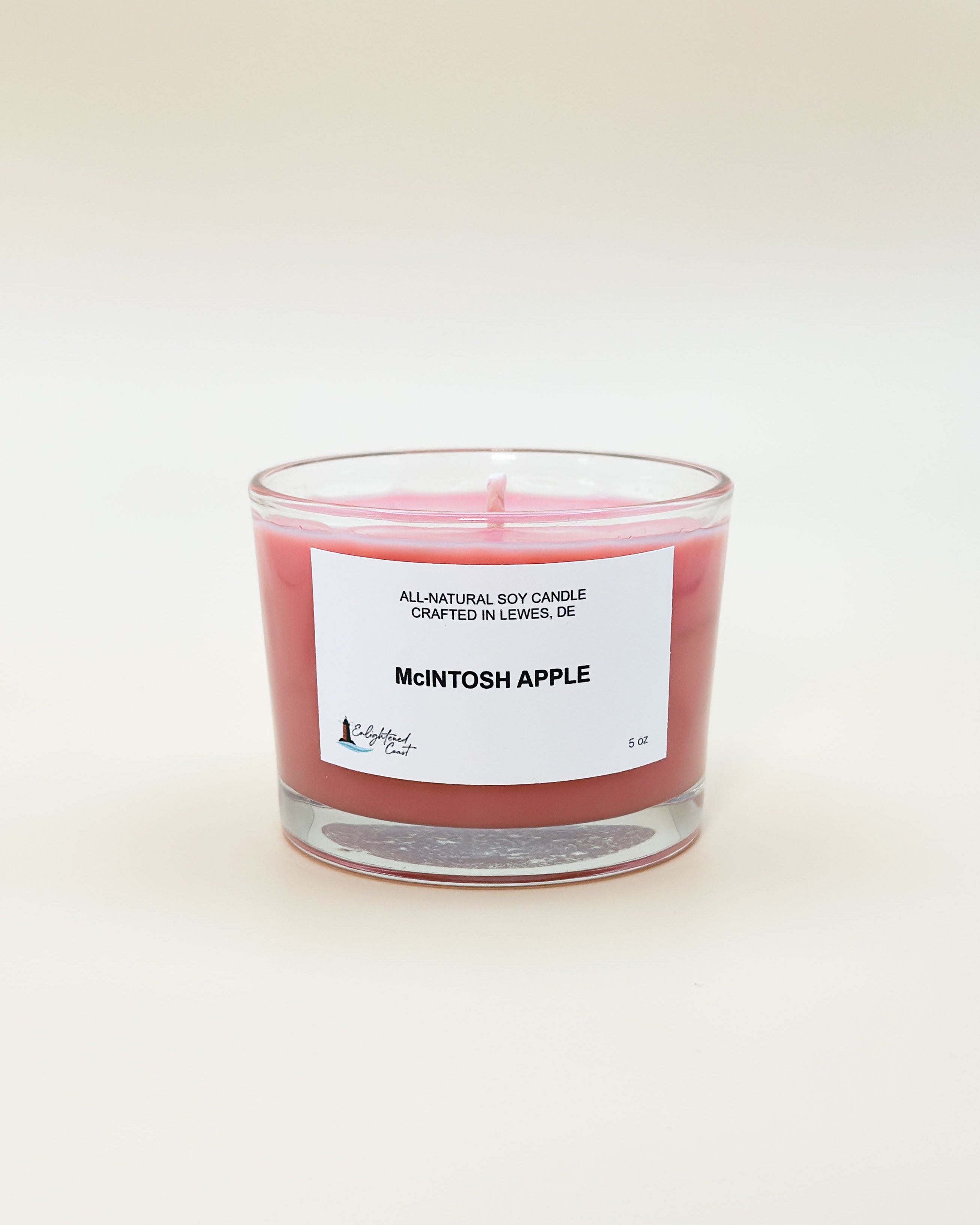 Red candle labeled 'Mcintosh Apple' on a white background