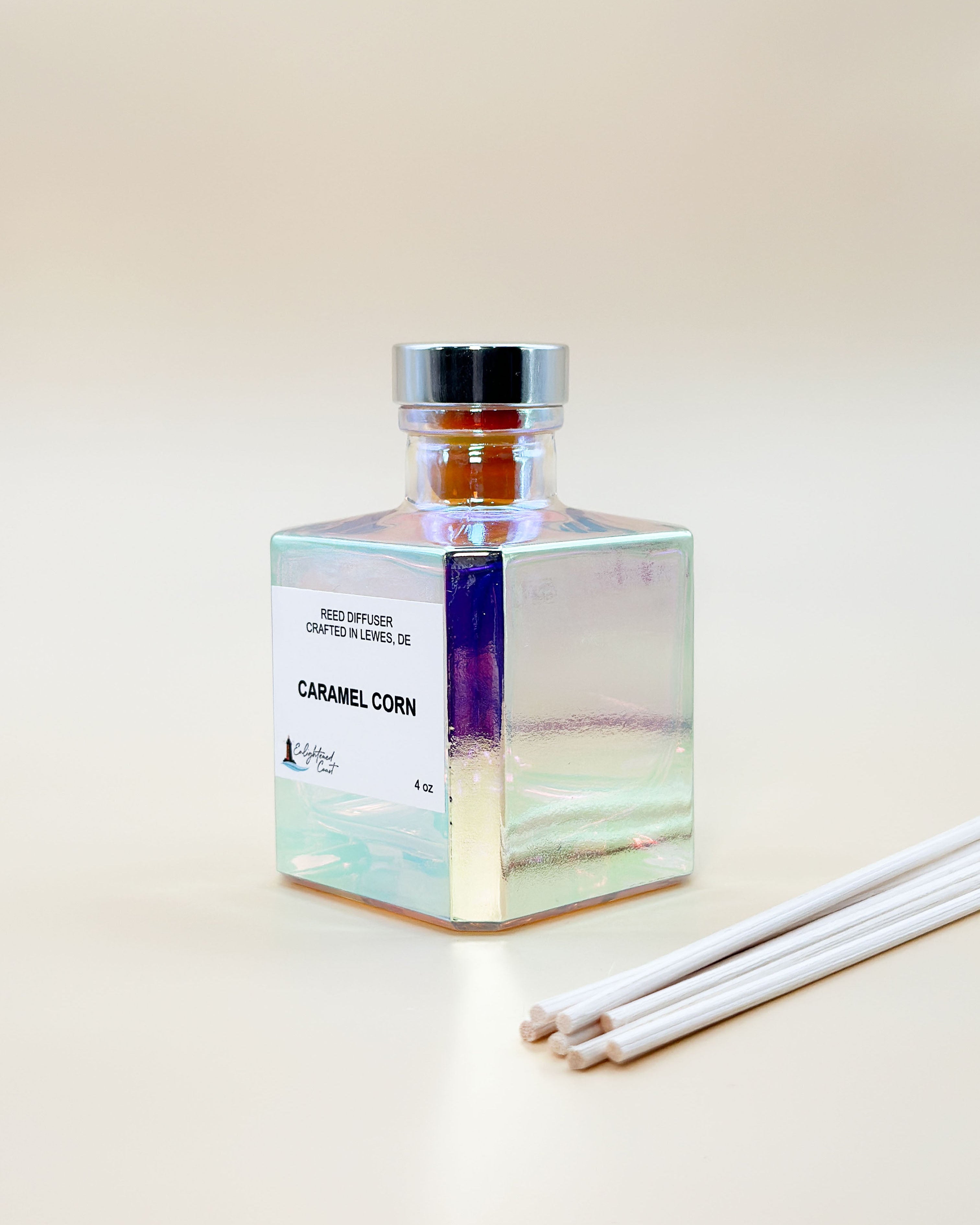 Square glass diffuser bottle on an angle with 'Caramel Corn' label on a light background