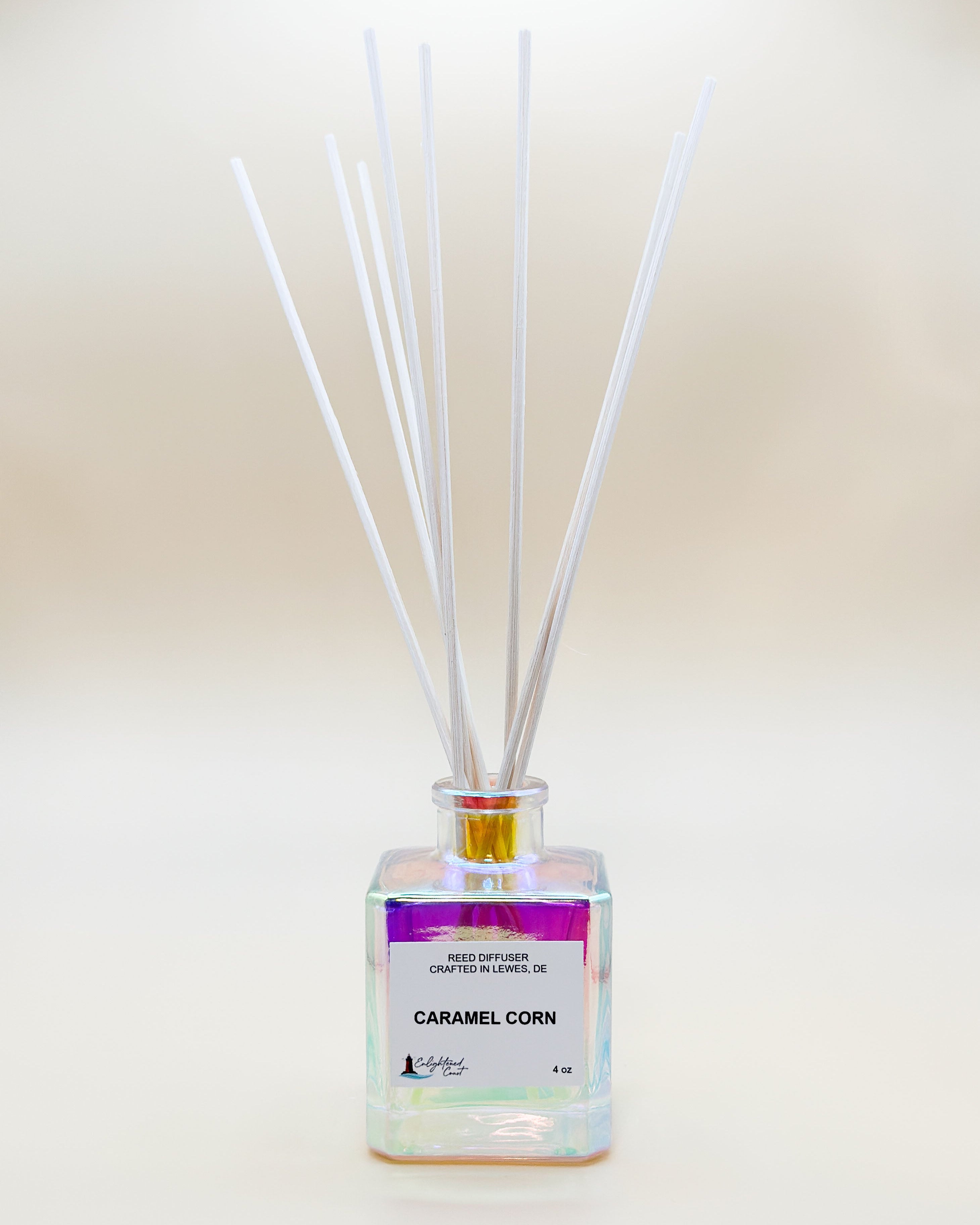 Reed diffuser with 'Caramel Corn' fragrance on a light background
