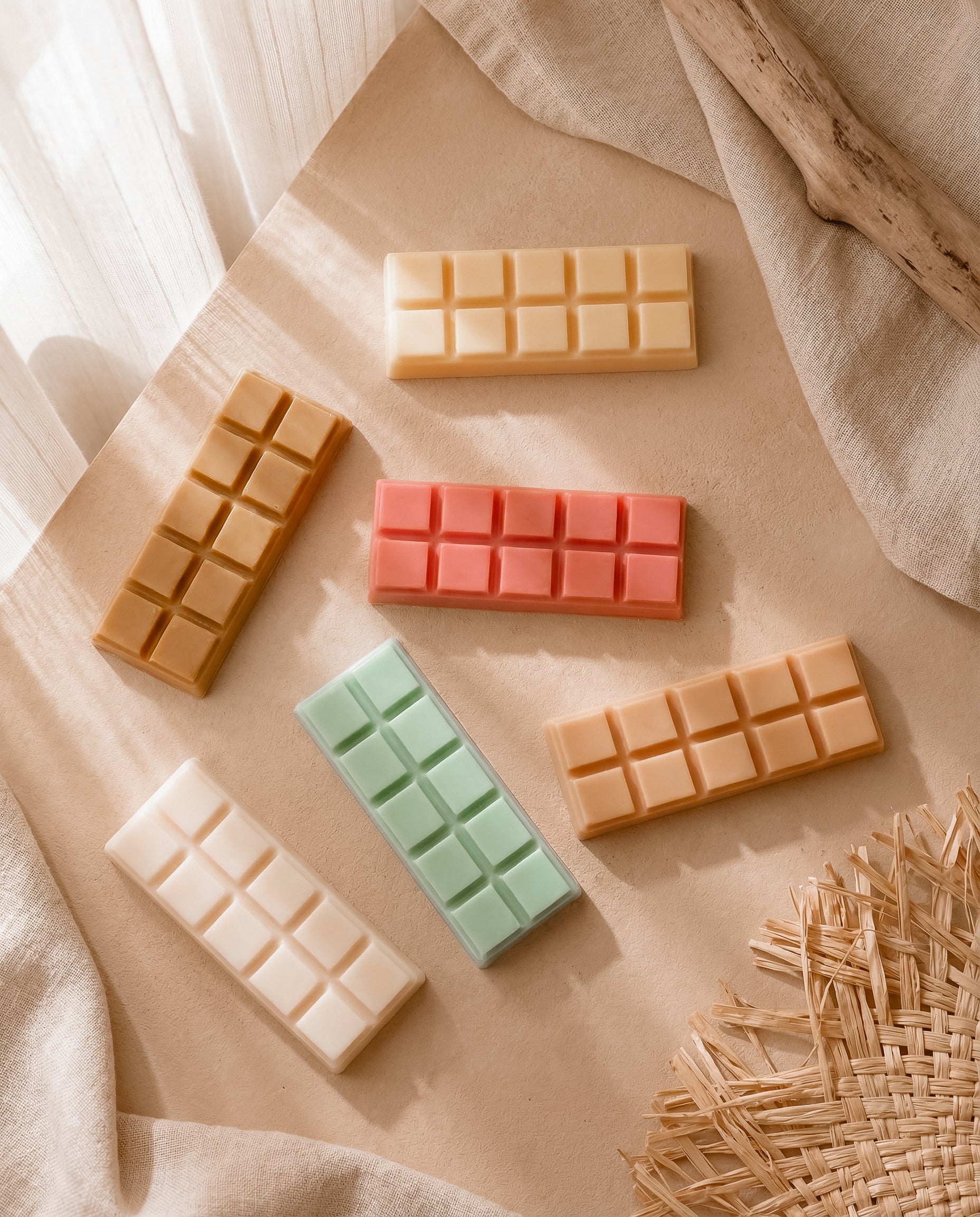 Colorful wax tarts on a textured surface with natural light